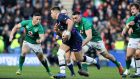 Ireland’s John Cooney goes to tackle Huw Jones of Scotland during their Six Nations encounter at Murrayfield. Photo: Dan Sheridan/Inpho