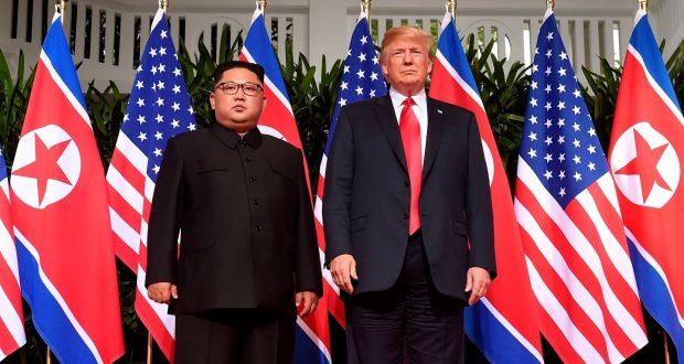 US president Donald Trump poses with North Korea’s leader, Kim Jong-un, at the start of their historic US-North Korea summit. Photograph: Saul Loeb / AFP