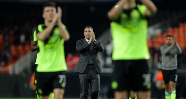 Brendan Rogers and his Celtic players thank their travelling fans. Photograph: Richard Heathcote/Getty Images