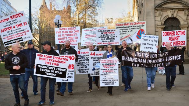 Supporters carry placards in St. Philip’s Cathedral Square before arriving at Birmingham Civil Justice centre. Photograph: Anthony Devlin/Getty Images