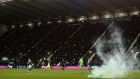 A flare on the pitch during Celtic’s 2-0 win away to Hibernian. Photograph: Mark Runnacles/Getty