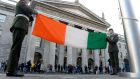 Two soldiers lower the  Irish flag  outside the General Post Office in Dublin. Photograph: Cyril Byrne/The Irish Times 