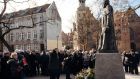 People pray by the restored monument of  late Fr Henryk Jankowski in Gdansk: supporters accuse Polish liberals of a witch hunt  against traditional Catholic values. Photograph:  Agencja Gazeta/Bartosz Banka 