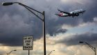  Storm clouds gathering: An American Airlines Boeing  737 Max 8 aircraft approaches  Miami International Airport in  Florida amid darkening conditions  on Tuesday.  Photograph: Scott McIntyre/Bloomberg