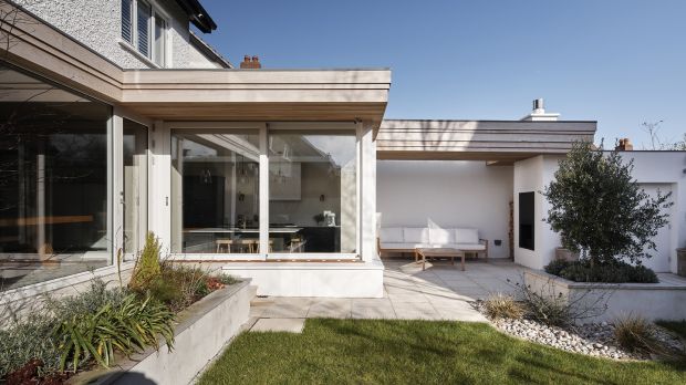 The fascia visually connects all three elements – the original back of the house, the kitchen extension and the new outdoor living space. Photograph: Ros Kavanagh