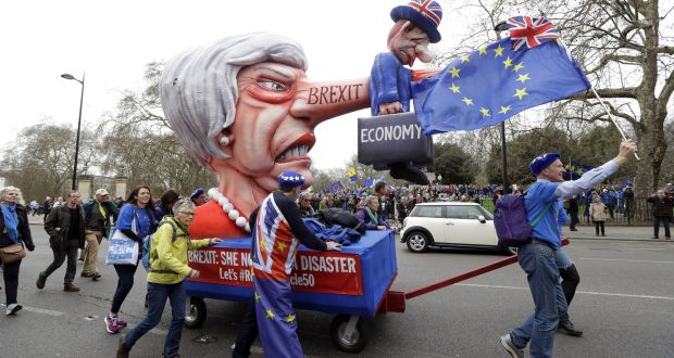 Demonstrators pull a cart with a doll resembling Theresa May during an anti-Brexit march in London on Saturday, Saturday. Photograph: Kirsty Wigglesworth/AP