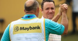  Scott Hend of Australia celebrates with his caddie after winning a playoff match against Nacho Elvira of Spain at the  Maybank Championship at Saujana Golf & Country Club in Kuala Lumpur, Malaysia. Photograph: Andrew Redington/Getty Images