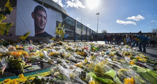 Yellow flowers are displayed in front of the portrait of Emiliano Sala at the Beaujoire stadium in Nantes. Photograph: Getty Images
