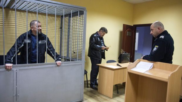 Oleg Smorodinov, in a defendant’s cage, on trial for the murder of Ivan Mamchur, in a courtroom in Rivne, Ukraine, on October 25th. Photograph: Joseph Sywenkyj/New York Times