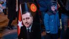 A boy stands next to a poster of Turkish president Recep Tayyip Erdogan in Istanbul on Sunday. Photograph:  Sedat Suna/EPA