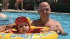 Swim baby: Conor Pope takes the littlest Pope into the pool at the Playa Montroig campsite just south of Barcelona for the very first time