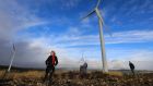 Fred O’Sullivan (right), chairman of the Sliabh Luachra Wind Awareness Group, with Peter and Caroline Cooke at the wind farm at Barna, near Scartaglen in Co Kerry. Photograph: Valerie O’Sullivan