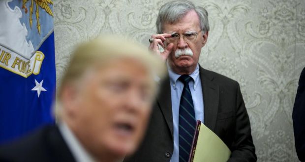 US national security advisor, John Bolton (background) looks on during a meeting between president Donald Trump and president of Chile, Sebastian Piñera in the Oval Office in September, 2018. Photograph: Oliver Contreras/The Washington Post/Getty
