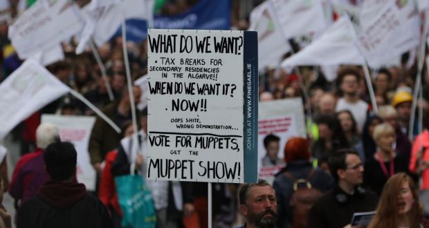 Placards are carried aloft at the Raise the Roof Rally in Dublin city centre. Photograph:  Nick Bradshaw/The Irish Times 
