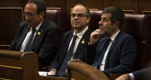 Jailed Catalan separatist leaders Josep Rull (left), Jordi Sanchez (right) and Jordi Turull (centre) attend to the opening plenary session at the Spanish Parliament in Madrid. Photograph: Pablo Blazquez Dominguez/ Pool/Getty Images