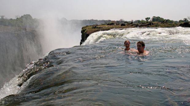 Tourists swimming at The Devil’s Pool at Victoria Falls. Photograph: Ian Restall/en.wikipedia