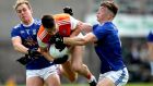 Armagh’s Niall Grimley is challenged by  Pádraig Faulkner and Conor Brady of Cavan during the Ulster SFC semi-final at  St Tiernach’s Park in  Clones. Photograph: Ryan Byrne/Inpho