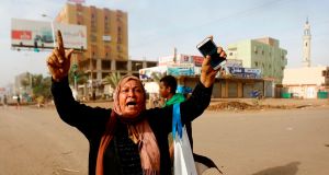 A Sudanese protester reacts as the military forces try to disperse the sit-in outside Khartoum’s army headquarters on Monday. Photograph: Getty Images