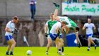 Fermanagh’s Ryan Jones takes a tumble as he’s challenged by Monaghan’s Kieran Hughes. Photograph: Tommy Dickson/Inpho