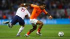 Memphis Depay of the Netherlands evades John Stones of England. Photograph: Dean Mouhtaropoulos/Getty