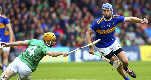 Tipperary’s John McGrath eludes Limerick’s Richie English  during the Munster championship clash at Thurles. Photograph: Ken Sutton/Inpho 