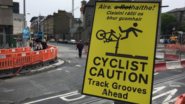 Safety sign warning cyclists about the dangers of cycling on the Luas rail lines.Photograph: Bryan O’Brien/The Irish Times