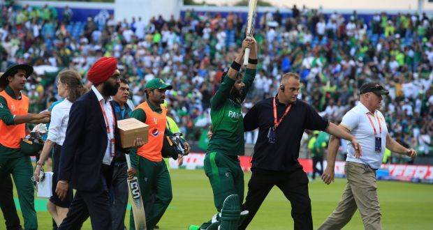 Pakistan’s Imad Wasim  is escorted off the field by security officials after the  Cricket World Cup  match against  Afghanistan at Headingley in Leeds. Photograph:  Lindsey Parnaby/AFP/Getty Images