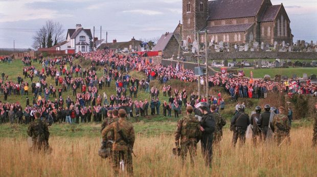 British soldiers and police officers look on as members of the Orange Order gather at Drumcree church in Portadown in 1998. Photograph: Joe St Leger.