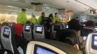 Emergency staff   treat a passenger on the Air Canada flight to Australia that was diverted and landed in Honolulu. Photograph: Hurricane Fall via AP
