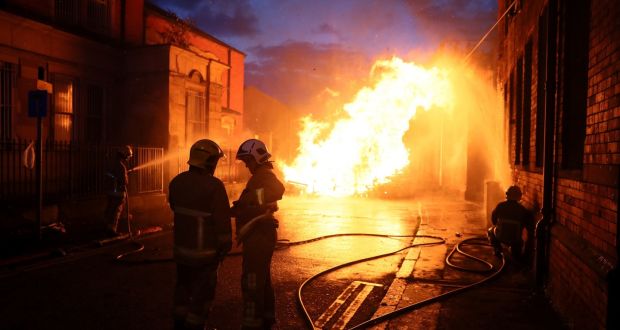 Members of the fire service work to contain an 11th night Bonfire in Cluan Place, Belfast. Photograph: Brian Lawless/PA Wire