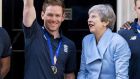 Britain’s prime minister Theresa May with England’s captain Eoin Morgan holding the World Cup trophy after beating New Zealand the final. Photograph:  Niklas Halle’n / AFP/Getty Images