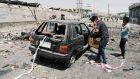 Cameraman films a damaged car at the site of a blast in Kabul. Photograph: Mohammad Ismail/Reuters