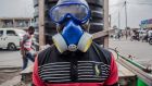 A health worker looks on as he wears protective gear to mix water and chlorine in Goma, the DRC. Photograph: Pamela Tulizo/AFP/Getty Images
