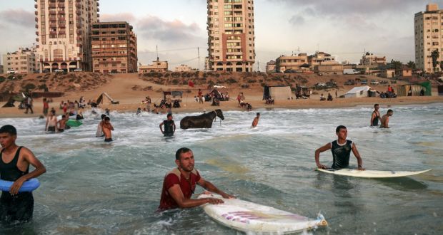 Surfing in Gaza. “The object was to show the relentlessness involved in trying to eke out some normality. The surfers enjoy themselves while gunboats loom in the distance”