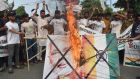 Activists of the “Youth Forum for Kashmir” group shout slogans as an Indian  flag with a picture of prime minister Narendra Modi is burned in Lahore, Pakistan on Monday. Photograph: Arif Ali/AFP/Getty Images