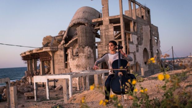 Karma, a 19-year-old cellist, plays facing the ocean in Gaza