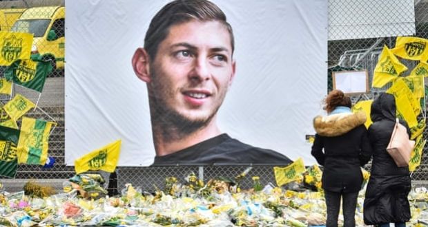 People look at tributes in front of a portrait of Emiliano Sala at the Beaujoire stadium in Nantes in February. Photograph: Loïc Venance/AFP/Getty Images