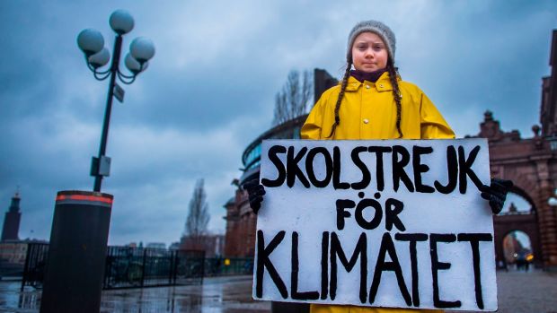 Swedish climate activist Greta Thunberg holds a placard reading ‘School strike for the climate’ during a protest outside the Swedish parliament in November. File photograph: Hanna Franzen/TT News Agency/AFP