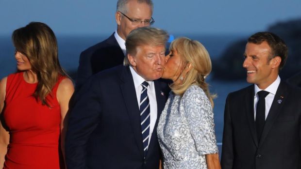 Brigitte Macron, wife of French president Emmanuel Macron, kisses Donald Trump, flanked by Melania Trump and Mr Macron. Photograph: Ludovic Marin/AFP/Getty