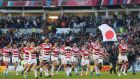 Japan players celebrate their surprise victory in the 2015 Rugby World Cup Pool B match between South Africa and Japan in Brighton. Photograph:  Charlie Crowhurst/Getty