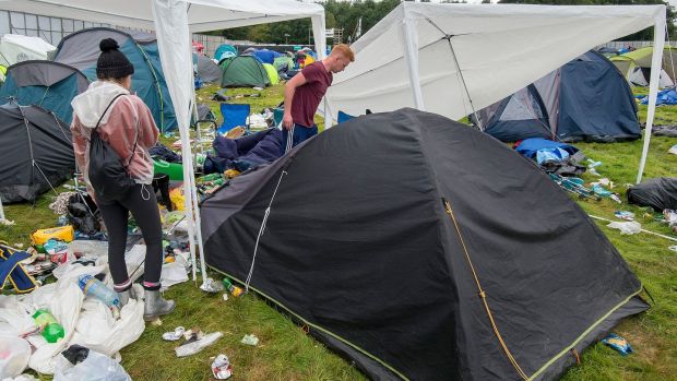 Nicole Casey, who has had her tent for five years, and Mark Hanrahan, from Limerick, packing up all their gear to bring home from Electric Picnic. Photograph: Dave Meehan for the Irish Times