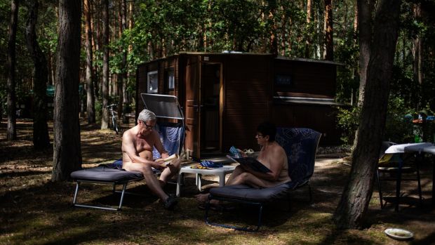 Nudists relax at a camp in Zossen, Germany. Photograph: Lena Mucha/New York Times