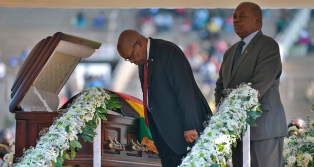 Former South African president Jacob Zuma (left) bows  as he stands by the casket of late former Zimbabwean president Robert Mugabe during a farewell ceremony held for family and heads of state at the National Sports Stadium in Harare on Saturday. Photograph: Tony Karumba/AFP/Getty