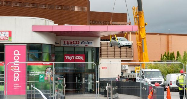 The first car is removed by crane from Douglas Village Shopping Centre, Cork following an accidental fire which severely damaged the multistorey car park earlier this month. Photograph: Daragh Mc Sweeney/Provision