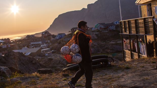 The coach of the team G-44 heads to the postgame meal in Sisimiut. Photograph: Kieran Dodds/New York Times