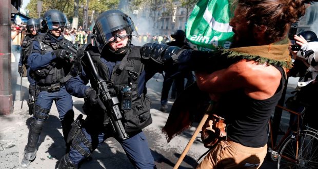 A demonstrator clashes with riot policemen during the climate change protest, September 21st in Paris. Photograph:  Zakaria Abdelkafi/ AFP/Getty 