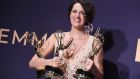 Phoebe Waller-Bridge with the three Emmys she won for her series Fleabag. Photograph:  Jordan Strauss/Invision/AP