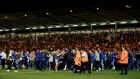  Colchester United fans invade the pitch following victory over Tottenham Hotspur. Photograph: Getty Images