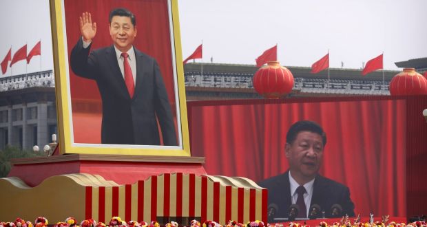 Participants cheer beneath a large portrait of Chinese president Xi Jinping during a parade to commemorate the 70th anniversary of the founding of Communist China in Beijing on Tuesday. Photograph: Mark Schiefelbein/AP
