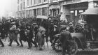 A convoy of Black and Tans and British soldiers arrives at the junction of Middle Abbey Street and O’Connell Street, Dublin, in 1921, during the War of Independence. Photograph: Sean Sexton/Getty Images
